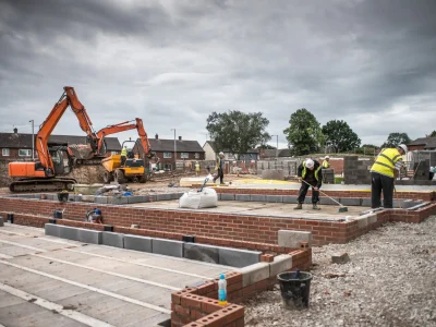 Workers laying bricks on construction site
